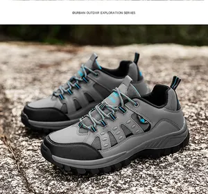 Close-up of durable gray hiking shoes with reinforced toe cap on outdoor rocky terrain