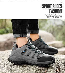 Close-up of high-top hiking boots with deep-tread anti-slip soles on natural rocks