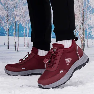 Waterproof burgundy hiking shoes for couples featuring non-slip soles on a snowy winter background