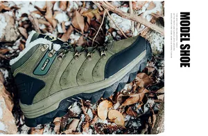 Close-up of military green outdoor hiking boots with warm white faux fur lining and metal lace hooks
