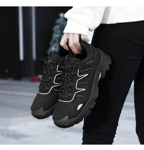 Detail of black sporty sneakers with mesh texture and white SPORT logo print