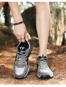 Detail of grey outdoor hiking shoes with breathable mesh and rugged lace-up design