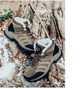 Detail of warm winter desert boots with thick fur lining on a snowy outdoor background