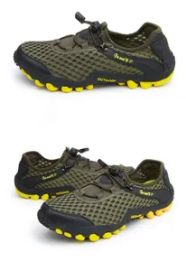Detail view of military green mesh hiking shoes with yellow non-slip rubber soles
