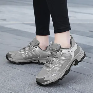 Outdoor view of gray mesh sport sneakers with thick non-slip soles for men and women