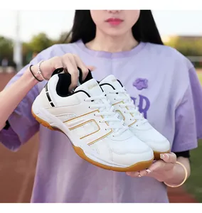 Detail view of white and gold non-slip badminton shoes with breathable mesh and gum soles