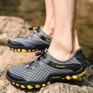 Breathable outdoor hiking shoes for men with grey mesh upper and yellow rubber grip sole
