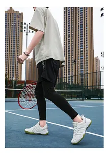 Outdoor shot of men's athletic wear including white tennis shoes and a racket
