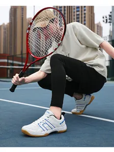 Detail of professional court shoes with blue geometric lines on white mesh and gum sole