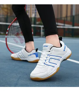 Close-up of white and blue court sports shoes with non-slip rubber soles in a stadium