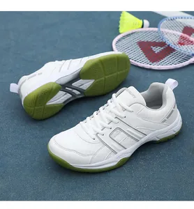 Detail showing white professional court shoe with breathable mesh and green rubber sole