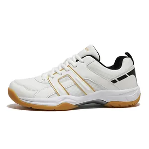 White indoor sports shoe with gold stripes and breathable mesh on a gum rubber outsole