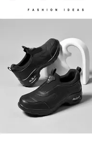 Detail of black air cushion platform sneakers featuring faux leather texture and slip-on design