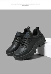 Detail of black leather platform hiking shoes with jagged non-slip soles and round logo