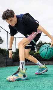 Close-up of multi-color basketball shoes featuring mint green and blue accents on court