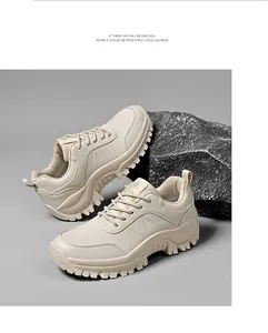 Close-up of beige platform hiking sneakers on a black textured rock background