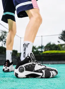 Detail of high-top basketball shoes featuring black and white contrast with shark-tooth panels