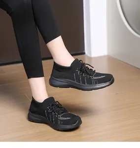 Dettaglio della tomaia in maglia nera con cuciture bianche ondulate su scarpe platform