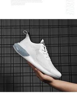 Close-up of breathable striped mesh upper and translucent cushioned sole on white running shoe