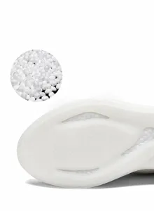 Detailed view of white anti-skid E-TPU popcorn sole with durable TPU texture and firm grip