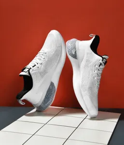 Detail of white mesh running shoe with breathable fabric and grey honeycomb cushion