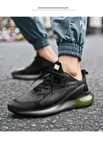 Detail of black mesh men's sneaker featuring green honeycomb cushioning unit and lace-up design