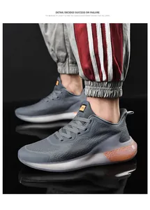 Detail of grey mesh running shoes featuring orange honeycomb cushioning and breathable fabric