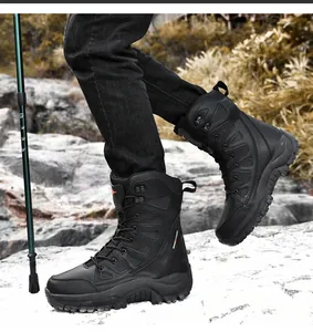 Outdoor detail of durable black high-top tactical boots with hiking pole on rocky terrain