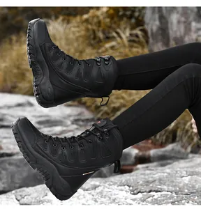 Close-up of durable black tactical boots on rocky terrain showing grip and lace-up design