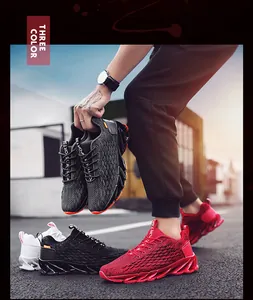 Outdoor street view of athletic blade running shoes in red, black, and white colors