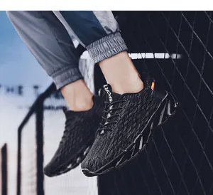 Close-up of black breathable mesh running shoes with white SPORT text on back strap