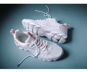 Macro detail of breathable mesh upper and blade cushioning sole on white running shoes