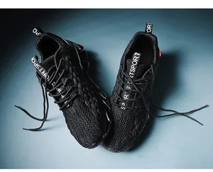Detailed macro shot of breathable knit mesh upper and SPORT lettering on black running shoes