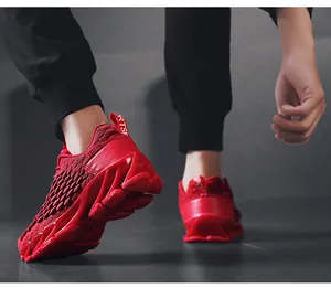 Low-angle side view of red knitted running shoes with blade-style shock-absorbing soles