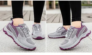 Close-up of women's breathable grey mesh sneakers with purple wavy sole and elastic laces