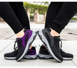 Outdoor shot showing breathable knitted sneakers with elastic lace system in purple and black