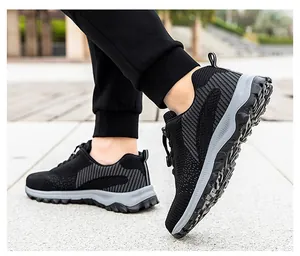 Side view of black breathable knit walking shoes with thick gray cushioning soles