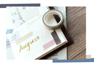 Close-up of grey-brown washi tape applied on a grid notebook for journal decoration