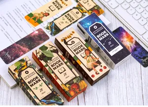 Artistic vintage bookmarks box set with star sky and floral illustrations on a desk