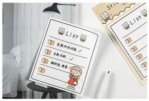 Detail of cute bear cartoon to-do list notepad on a white desk with stationery