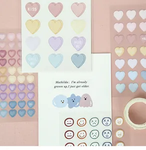 Detail of heart and emoji stickers in pastel colors for DIY scrapbooking decor