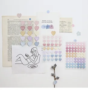 Detail of heart-shaped stickers in macaron tones with KISS and LOVE text for DIY journaling