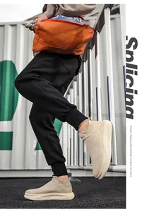 Beige knitted sock sneakers with thick cushioned soles shown in a street style setting