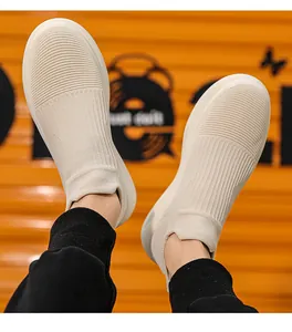 Macro detail of breathable knitted mesh fabric and thick sole on cream slip-on sneakers