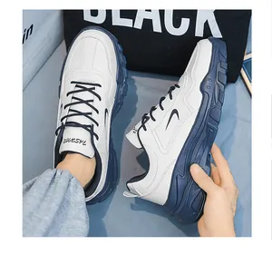 Vue latérale de baskets en cuir blanc et bleu avec inscription mode sur la languette
