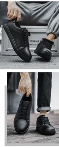 Detail view of black minimalist casual sneakers with matte leather and anti-slip sole