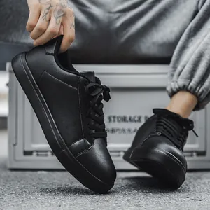 Minimalist all black low top casual sneakers for men with matte leather finish and flat sole