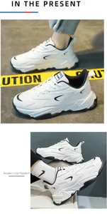 Detail view of white chunky sneakers with layered leather stitching and thick rubber soles