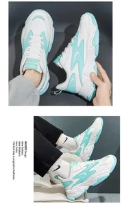 Close-up of white and mint green platform sneakers with chunky soles and lace-up detail