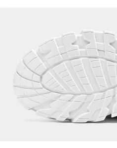 Macro shot of white chunky outsole featuring anti-slip gear patterns and EVA texture
